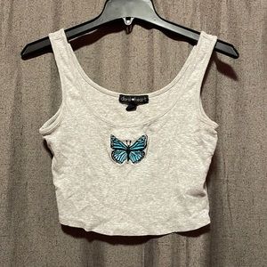 Grey crop top with a blue butterfly in the middle